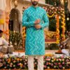 The image features a men's teal blue printed kurta, which is a popular choice for festive and cultural occasions in South Asia. This specific piece is crafted from soft cotton and characterized by its vibrant zig-zag or geometric print. Mirraw.com Mirraw.com Key Features and Style Tips Design Details: The kurta typically includes a mandarin collar, full sleeves, and side pockets for practicality. Fabric: Most versions of this design are made from breathable cotton or cotton blends, making them suitable for warm weather and day-long celebrations. Pairing: For a classic look, this kurta is traditionally paired with white or off-white pyjamas or churidars. To complete the ensemble, consider traditional footwear like mojris or brown dress shoes