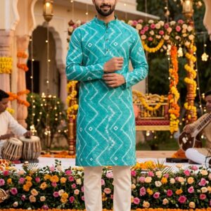 The image features a men's teal blue printed kurta, which is a popular choice for festive and cultural occasions in South Asia. This specific piece is crafted from soft cotton and characterized by its vibrant zig-zag or geometric print. Mirraw.com Mirraw.com Key Features and Style Tips Design Details: The kurta typically includes a mandarin collar, full sleeves, and side pockets for practicality. Fabric: Most versions of this design are made from breathable cotton or cotton blends, making them suitable for warm weather and day-long celebrations. Pairing: For a classic look, this kurta is traditionally paired with white or off-white pyjamas or churidars. To complete the ensemble, consider traditional footwear like mojris or brown dress shoes